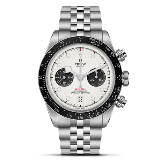 The TUDOR Black Bay Chrono features a stainless steel bracelet, T-Fit clasp, white dial, black bezel with tachymeter scale, three sub-dials, two chronograph pushers, and a date window at 6 o'clock.