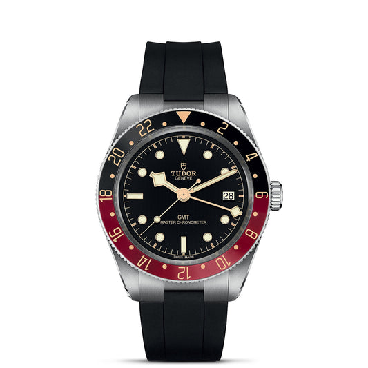 The TUDOR Black Bay 58 GMT showcases a black dial with silver hour markers and an eye-catching red and blue bezel. Equipped with a rubber strap, this watch features "GMT Master Chronometer" branding on the dial and includes a convenient date display on the right side of the face for enhanced functionality.