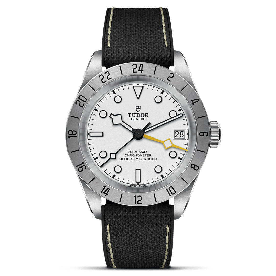 The TUDOR Black Bay Pro wristwatch combines a silver case with a white dial and black markers. Featuring the TUDOR Manufacture Calibre MT5652, it offers a date display at 3 o'clock and dual time zones. A black fabric strap with white stitching adds style to this TUDOR watch.