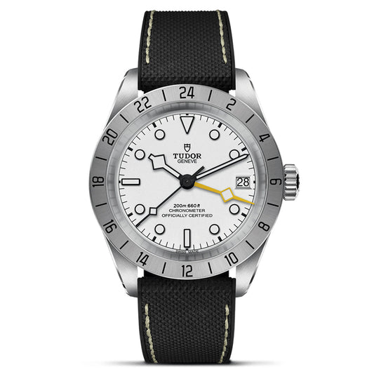 The TUDOR Black Bay Pro wristwatch combines a silver case with a white dial and black markers. Featuring the TUDOR Manufacture Calibre MT5652, it offers a date display at 3 o'clock and dual time zones. A black fabric strap with white stitching adds style to this TUDOR watch.