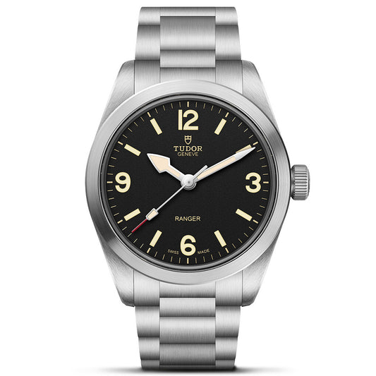 The TUDOR Ranger, a stainless steel watch by TUDOR, features a black dial with luminous hands and markers, numerals at 12, 3, 6, and 9, a brushed metal bracelet, Manufacture Calibre MT5400 movement, and "Ranger" above 6 o’clock.