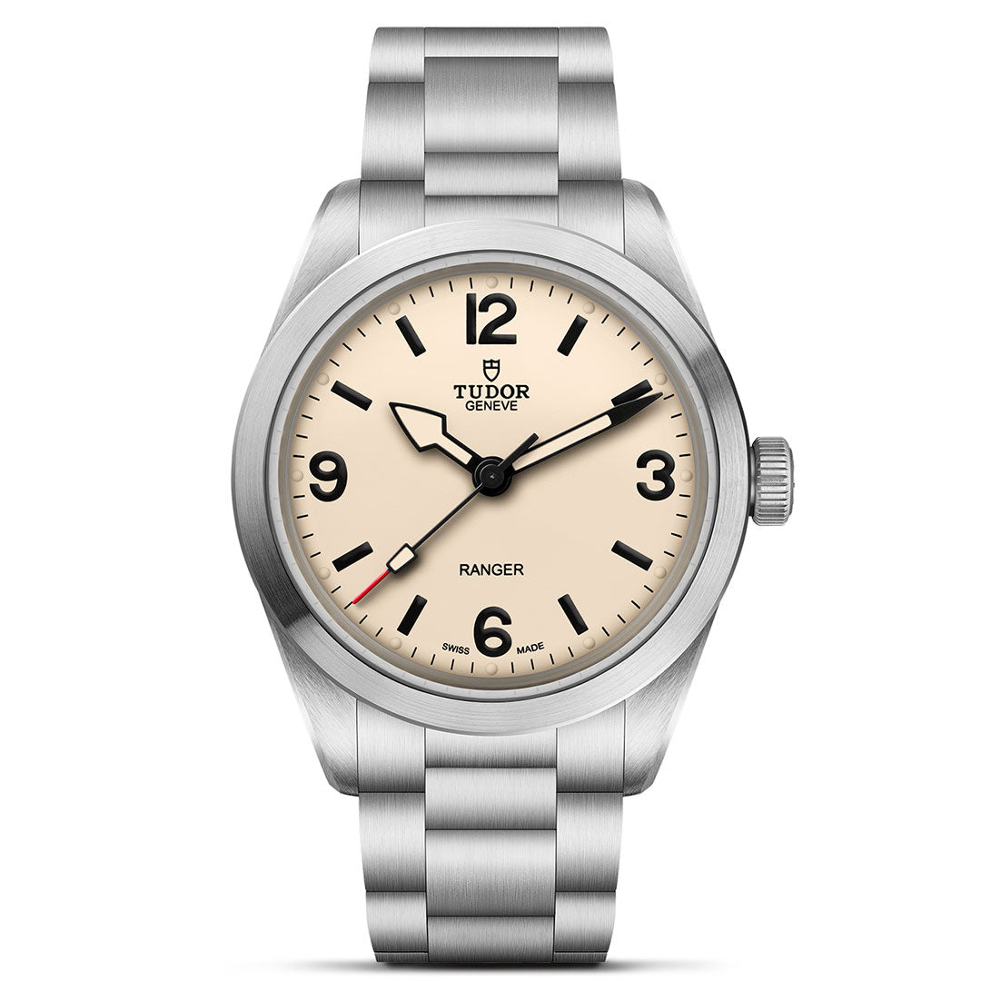 The TUDOR Ranger by TUDOR features a beige dial, black hour markers and hands, stainless steel case and bracelet, Manufacture Calibre MT5400, with the Tudor logo and "Ranger" displayed above 6 o'clock.