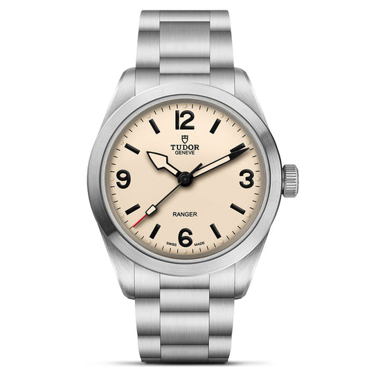 The TUDOR Ranger by TUDOR features a beige dial, black hour markers and hands, stainless steel case and bracelet, Manufacture Calibre MT5400, with the Tudor logo and "Ranger" displayed above 6 o'clock.