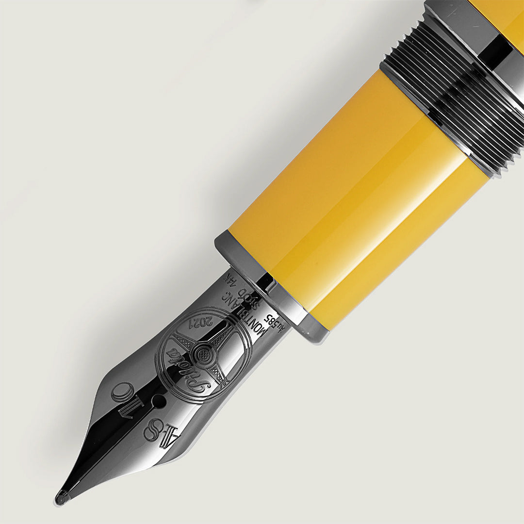 A close-up showcases the Montblanc Great Characters Enzo Ferrari Special Edition Giallo Modena Fountain Pen, featuring a brilliant yellow body and a shiny silver nib with intricate engravings, reflecting Enzo Ferrari's renowned attention to detail against a soft, neutral background.