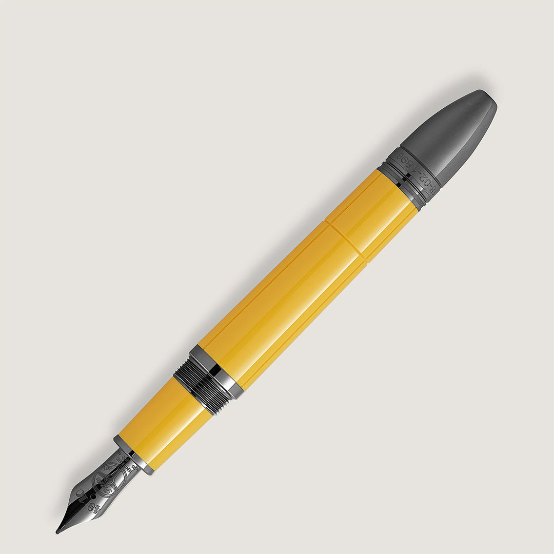 The Montblanc Great Characters Enzo Ferrari Special Edition Giallo Modena Fountain Pen, featuring a silver nib and black accents, is displayed diagonally on a light gray background.
