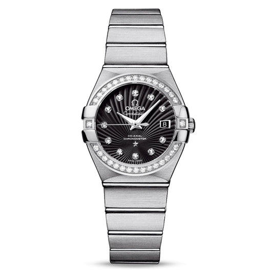 The OMEGA Constellation Co-Axial Chronometer 27mm Watch captivates with its diamond-set bezel and black dial. Adorned with diamond hour markers and a date window at 3 o'clock, it features the precision of the Co-Axial calibre 8520 movement and is tastefully completed with a stainless steel bracelet.