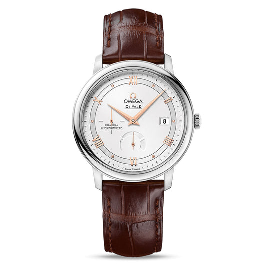 The OMEGA De Ville Prestige Co-Axial Chronometer Power Reserve 39.5mm Watch offers a timeless and sophisticated style with luxurious detailing, highlighted by its silver case, white dial, and rose gold hour markers. It features a brown leather strap that complements an elegant date window positioned at 3 o'clock and a small seconds subdial located above the 6 o'clock mark.