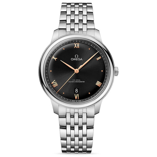 The OMEGA De Ville Prestige Co-Axial Master Chronometer 40mm Watch, by OMEGA, showcases a black dial adorned with gold Roman numerals and includes a date display at the 6 o'clock position. This model, crafted from stainless steel, features a co-axial master chronometer movement that ensures both precision and elegance every moment.