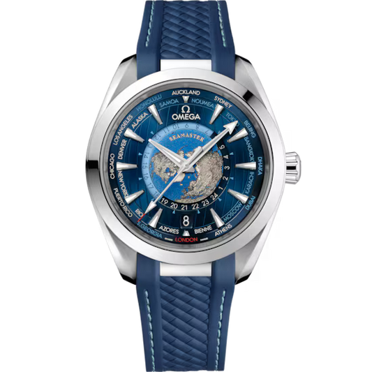 OMEGA Seamaster Aqua Terra 150M Worldtimer Co-Axial Master Chronometer 43mm watch with a blue textured strap, stainless steel case, world map blue dial, city names on the edge, Calibre 8938 precision, and date window above 6 o’clock.