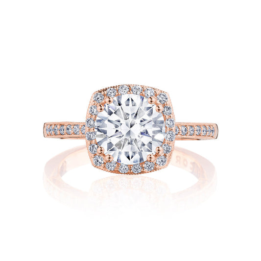 Explore the captivating allure of the Tacori Coastal Crescent engagement ring. This exquisite piece, crafted from 14K rose gold, showcases a mesmerizing round diamond at its heart, surrounded by a halo of smaller diamonds. The ring's band is elegantly accented with additional brilliant diamonds for an enchanting sparkle.