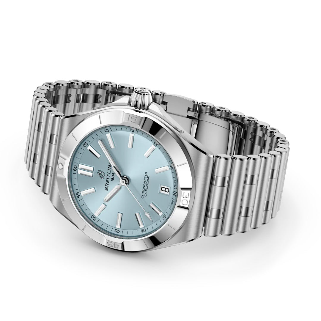 The BREITLING Chronomat B31 Automatic 40 is a COSC-certified watch with a stainless steel case, light blue dial, date at 6 o’clock, and silver hour markers, shown angled on a matching metal bracelet.