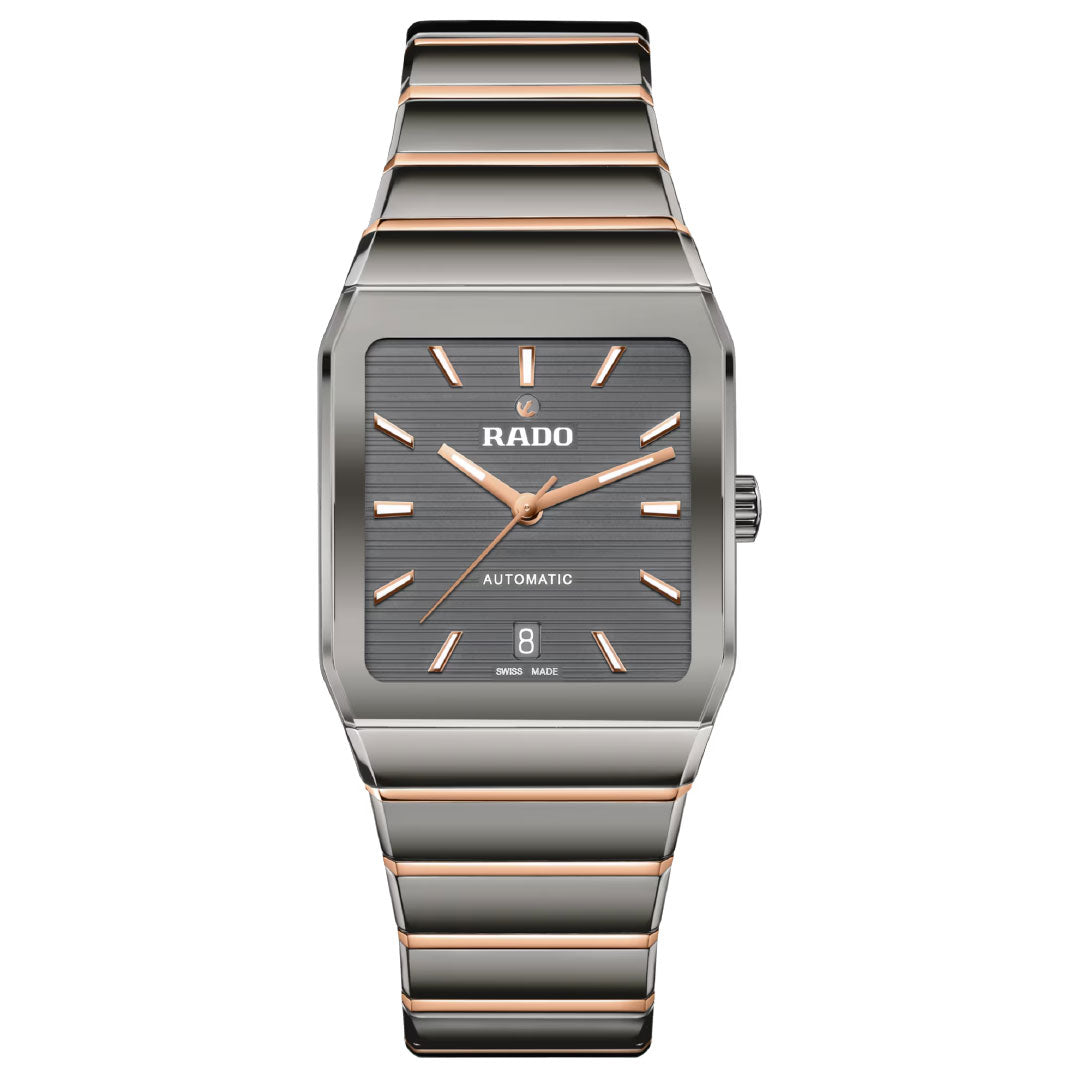 The Rado Anatom Automatic 32.5mm Watch features a rectangular case, grey dial, rose gold hour markers and hands, date at 6 o’clock, "RADO AUTOMATIC" on the dial, a sapphire crystal, and a silver/rose gold striped metal bracelet.