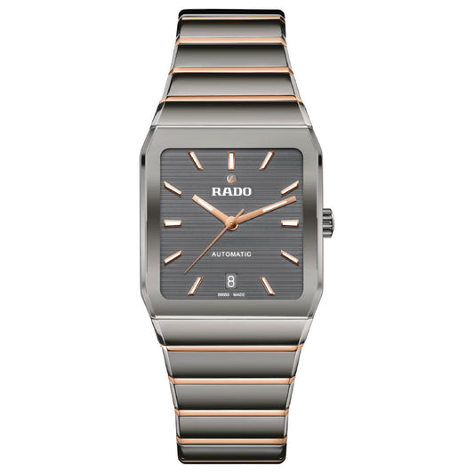 The Rado Anatom Automatic 32.5mm Watch features a rectangular case, grey dial, rose gold hour markers and hands, date at 6 o’clock, "RADO AUTOMATIC" on the dial, a sapphire crystal, and a silver/rose gold striped metal bracelet.