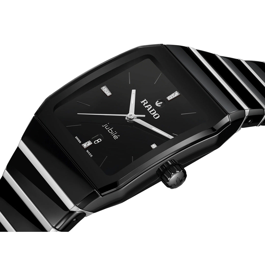 A close-up view of the RADO Anatom Automatic 27.5mm watch, featuring a sleek black rectangular face, silver-tone hands, diamond hour markers, date display, and a glossy high-tech ceramic bracelet by RADO.