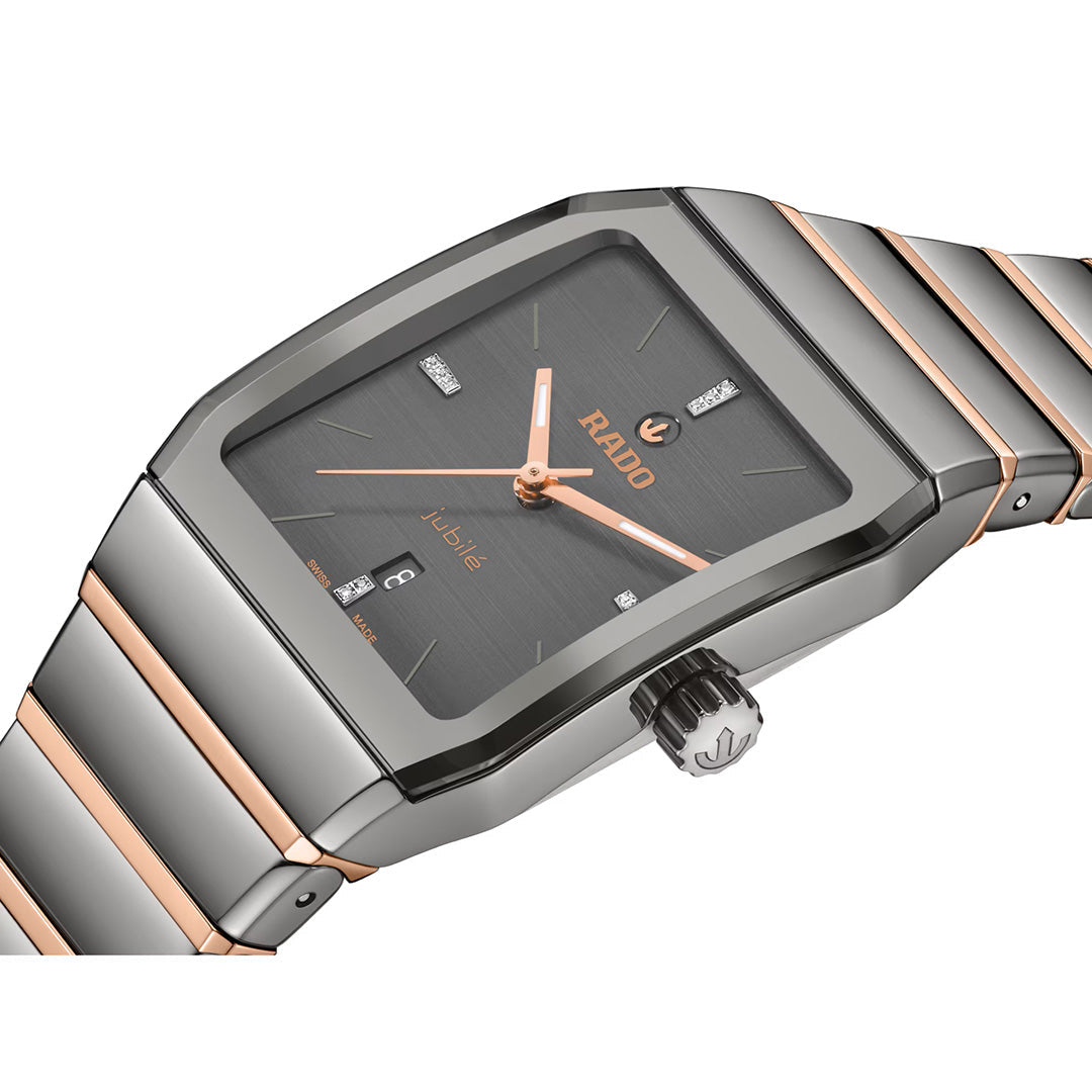 A close-up of the RADO Anatom Automatic 27.5mm watch showcases its rectangular face, black dial, rose gold accents, diamond hour markers, and a two-tone silver and rose gold metal band—elements that highlight the elegance synonymous with RADO’s high-tech ceramic timepieces.