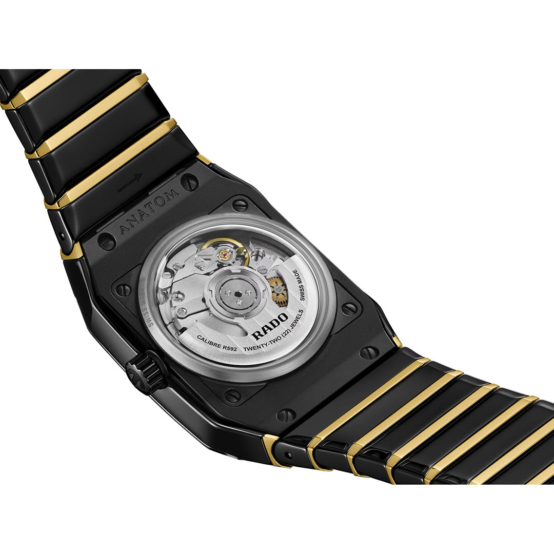 Close-up of the back of the RADO Anatom Automatic 27.5mm Watch, highlighting the transparent case back with visible mechanical movement and engraved details, crafted in black high-tech ceramic by RADO.