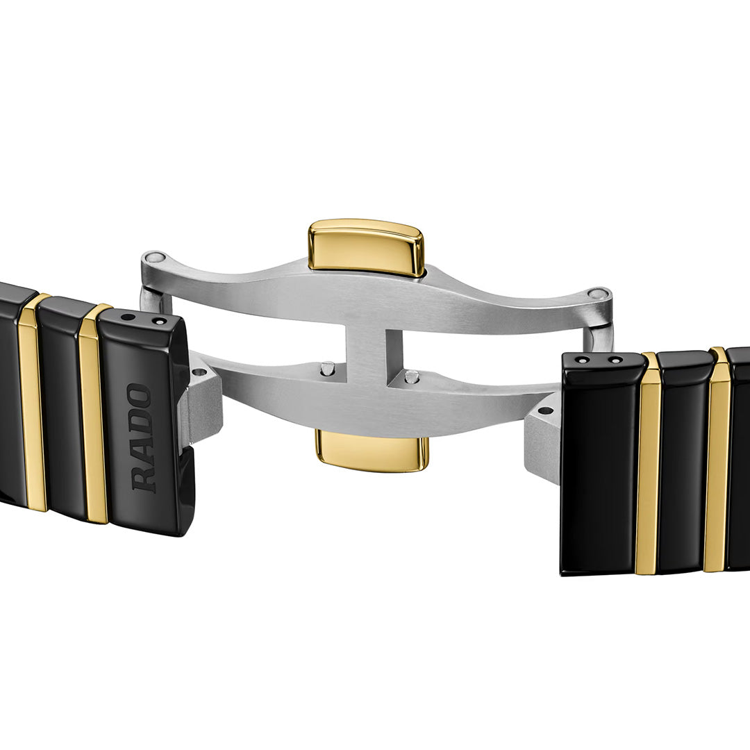 Close-up of the RADO Anatom Automatic 27.5mm Watch band, showcasing black high-tech ceramic segments accented with gold and a two-tone stainless steel folding clasp.