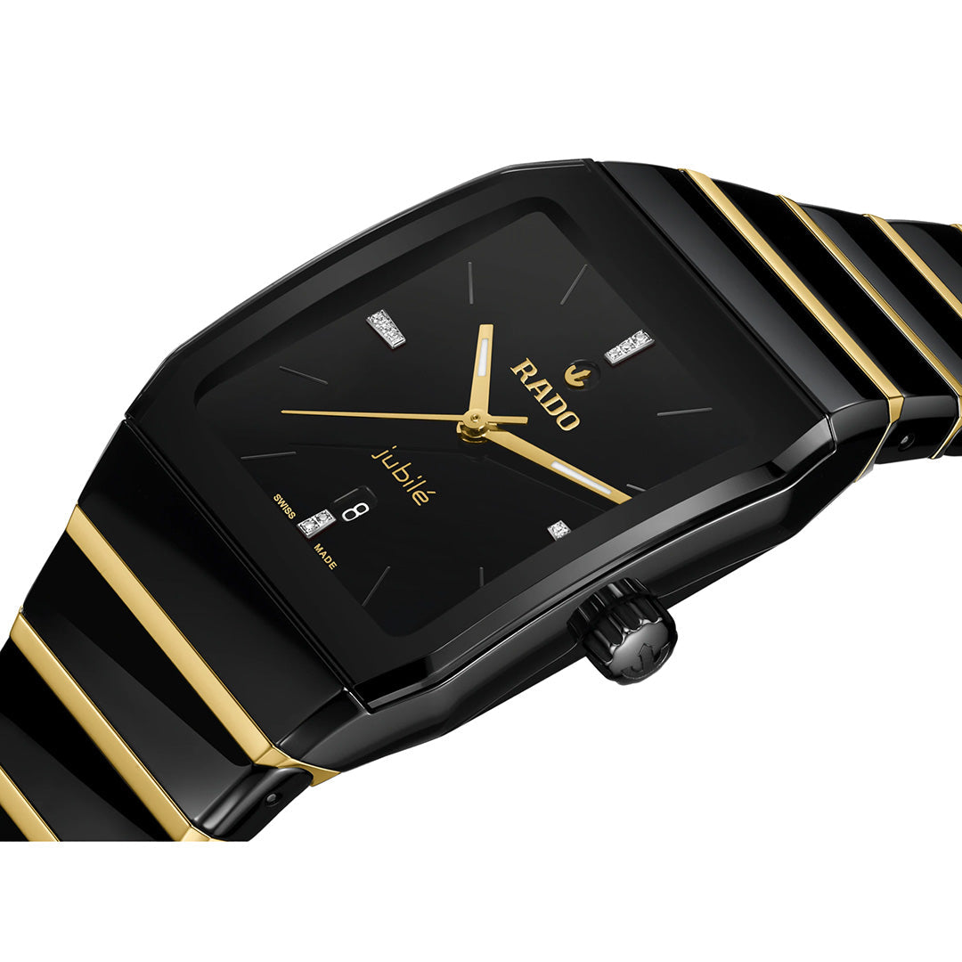 A black and gold RADO Anatom Automatic 27.5mm wristwatch with a rectangular face, gold hands, diamond hour markers, and a date display is shown at an angle on a white background—a striking example of RADO’s high-tech ceramic craftsmanship and sophisticated automatic luxury timepiece design.