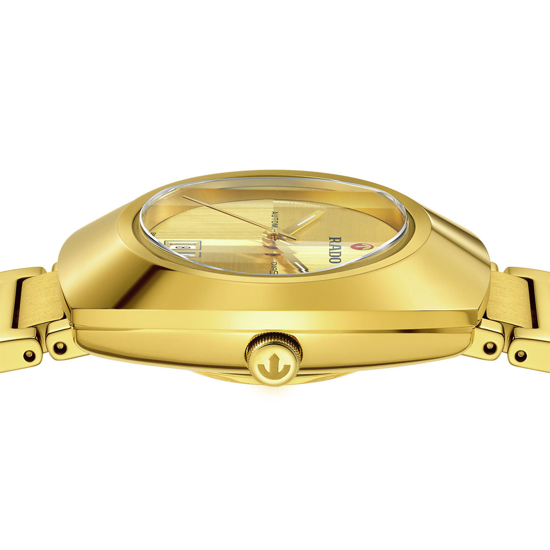 Side view of a RADO Diastar Original Automatic 30mm watch with a gold metal band, logo crown, and yellow dial under clear crystal. "RADO" is printed on the dial, showcasing Swiss craftsmanship.