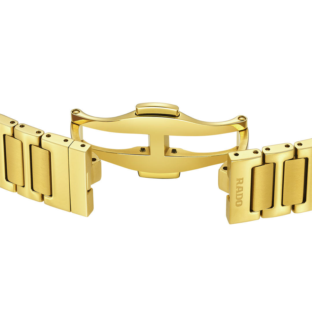 Close-up of a gold metal bracelet with a butterfly clasp, partly open to show the RADO logo—highlighting Swiss craftsmanship and the timeless elegance of the RADO Diastar Original Automatic 30mm Watch.