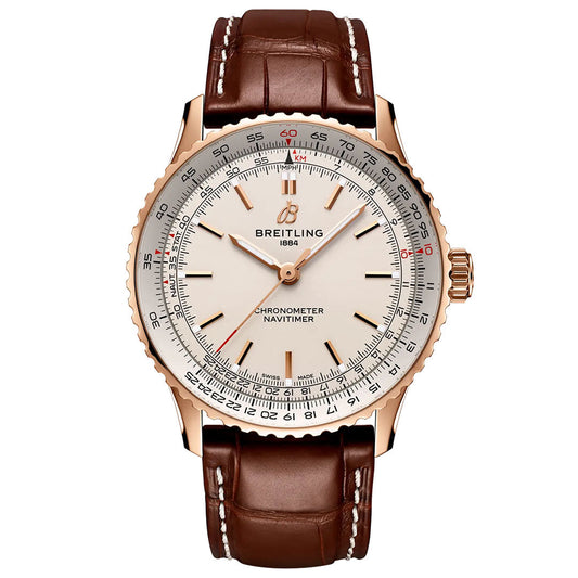 The Breitling Navitimer Automatic 41 features a brown leather strap, gold case, and a white dial adorned with detailed markings, including a chronometer scale and red accents. The Breitling logo and "1884" appear below 12 o’clock on this iconic automatic GMT timepiece.