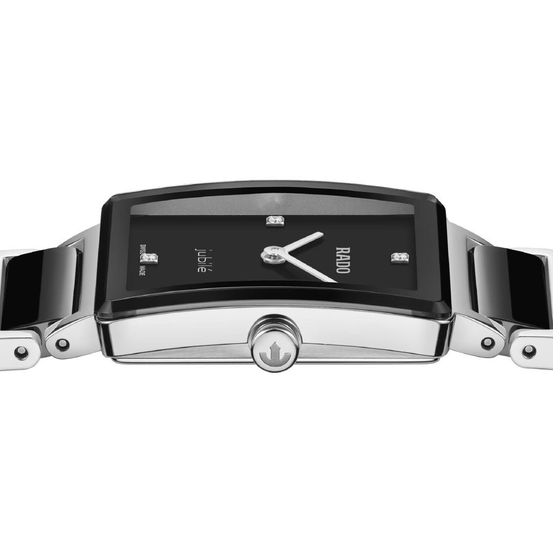 A close-up side view of the RADO Integral Diamonds Quartz 23mm Watch, featuring a black rectangular dial, silver bezel and bracelet, high-tech ceramic design, sapphire crystal, and sparkling diamond hour markers.