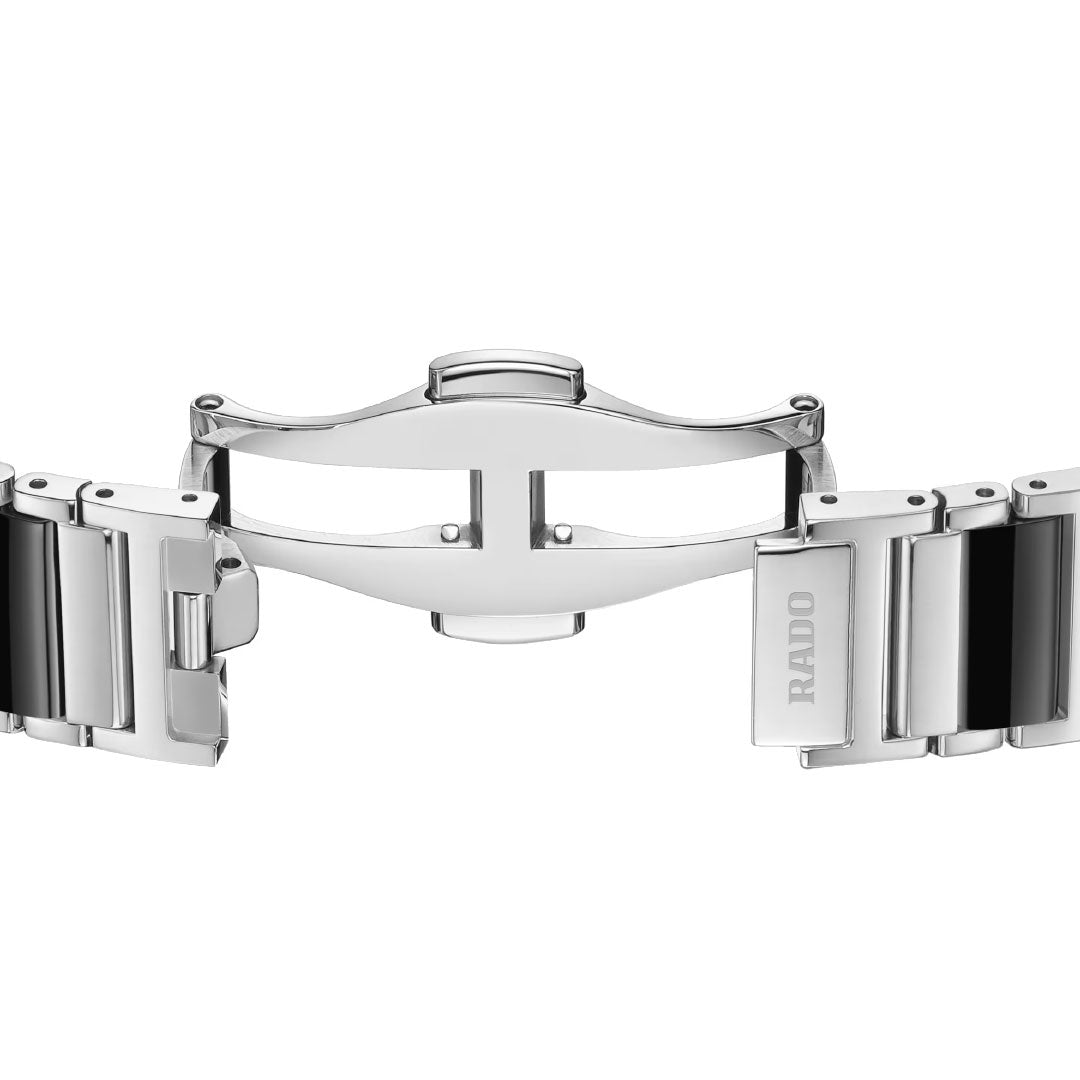 Close-up of the open deployment clasp on the RADO Integral Diamonds Quartz 23mm watch, showing its polished silver finish, black ceramic links, and "RADO" engraving.