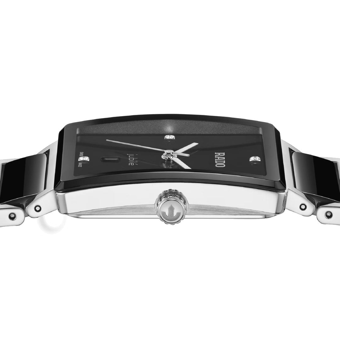 A close-up side view of the RADO Integral Diamonds Quartz 31.5mm watch showcases its sleek rectangular black and silver design, metal band, visible crown, silver hands and markers, and precise Swiss quartz movement.