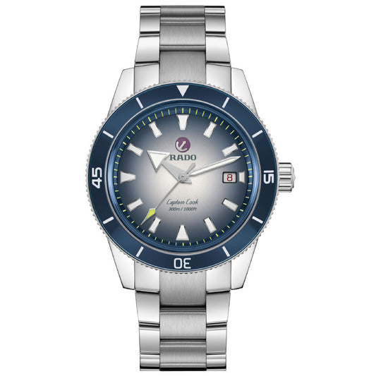 The RADO Captain Cook Automatic 42mm Watch features a stainless steel case, blue bezel, silver gradient dial, luminous hands, date at 3 o'clock, 80-hour power reserve, and is water-resistant up to 300M.