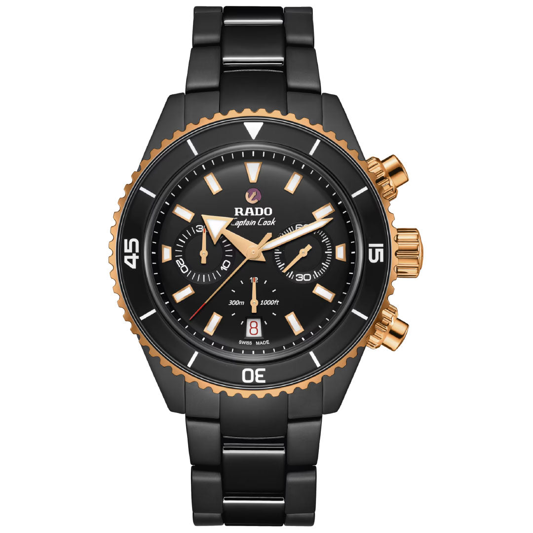 The RADO Captain Cook High-Tech Ceramic Automatic Chronograph 43mm Watch features a black and gold design, round face, bold white markers, two subdials, date window at 6 o’clock, and three gold crowns on the right side.