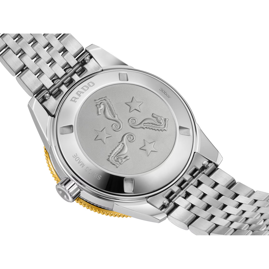 The back of the RADO Captain Cook Automatic 39mm Watch showcases engraved seahorses and stars, complemented by a metal link bracelet and the polished details of the casing—an elegant tribute to RADO’s craftsmanship within their renowned Captain Cook collection.