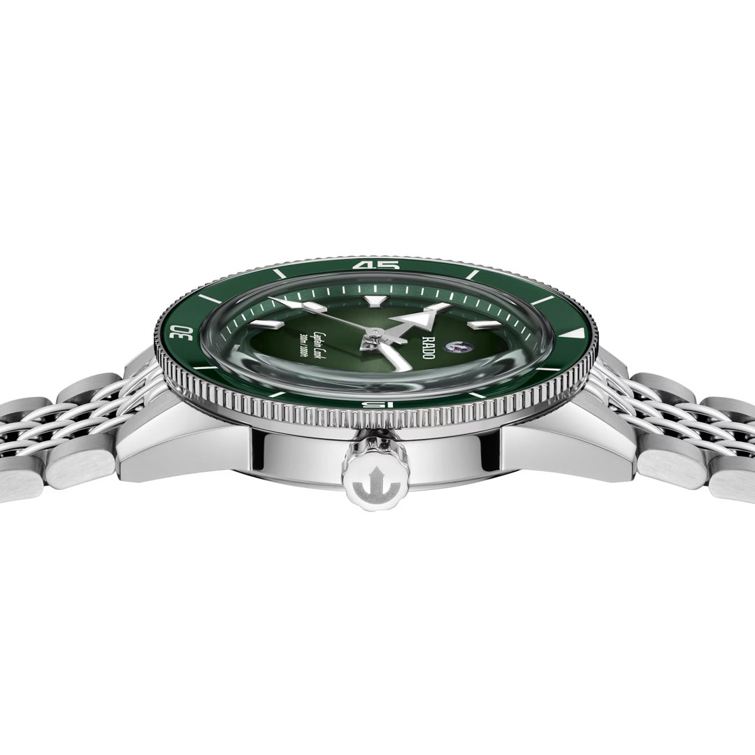 A close-up side view of the RADO Captain Cook Automatic 39mm Watch, featuring a green dial, silver-toned metal link bracelet, and highlighting the detailed crown along with its high-tech ceramic bezel.