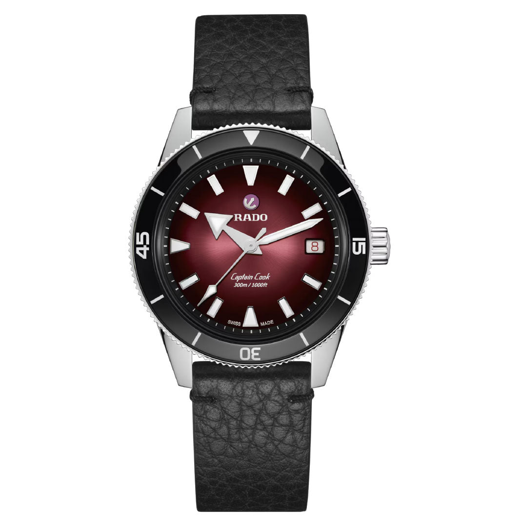 The RADO Captain Cook Automatic 39mm watch features a stainless steel case, black leather strap, gradient burgundy dial with white markers, date at 3 o’clock, silver-tone hands, and automatic movement.
