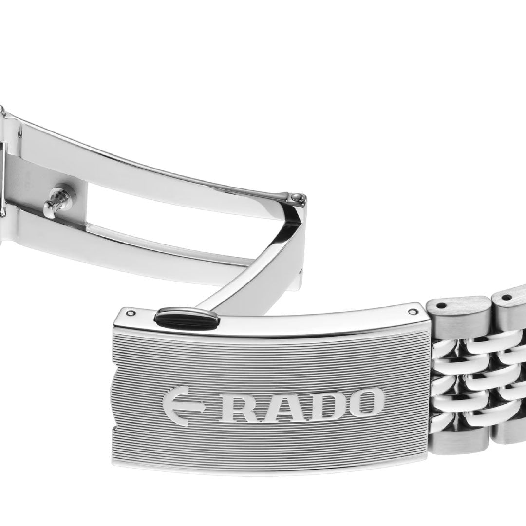Close-up of a silver metal clasp engraved with "RADO" on the Captain Cook Automatic 39mm Watch, revealing its intricate link design and signature high-tech ceramic elements.