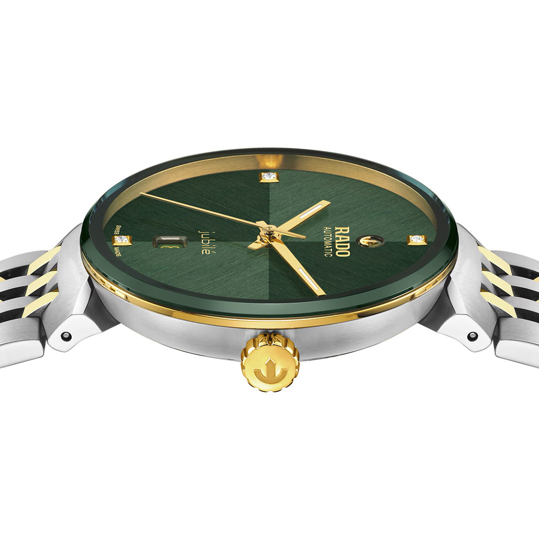 A close-up side view of the RADO Florence Automatic 39mm Watch showcases its elegant green dial, gold accents, diamond hour markers, and two-tone metal band, all beautifully protected by a scratch-resistant sapphire crystal.