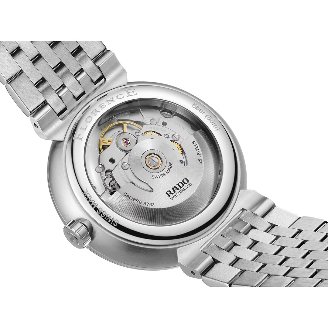 Close-up of the back of a RADO Florence Automatic 39mm Watch, highlighting its automatic movement visible through a transparent sapphire crystal case back. The stainless steel bracelet and engraved details from the Swiss-made RADO timepiece are also shown.
