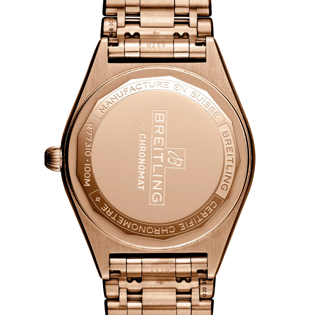 The back of the BREITLING Chronomat 32 showcases engravings with the Breitling brand name, model details, and specifications such as RT7310 and 100M water resistance. This elegant wristwatch also features a diamond-set bezel, elevating its iconic design with a luxurious touch.