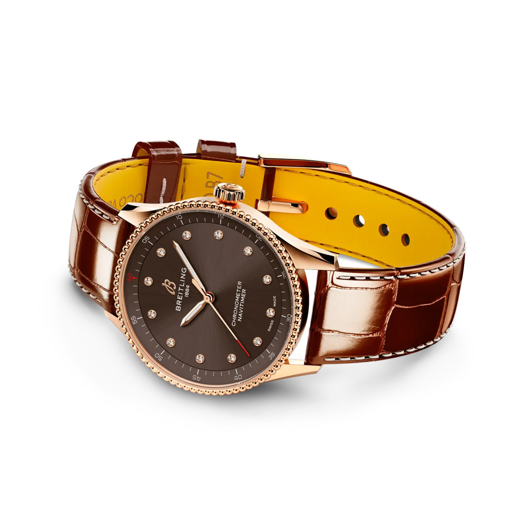 A BREITLING Navitimer 32 luxury watch by Breitling with a brown leather strap, gold case, and black dial with diamond hour markers, displayed on a white background.