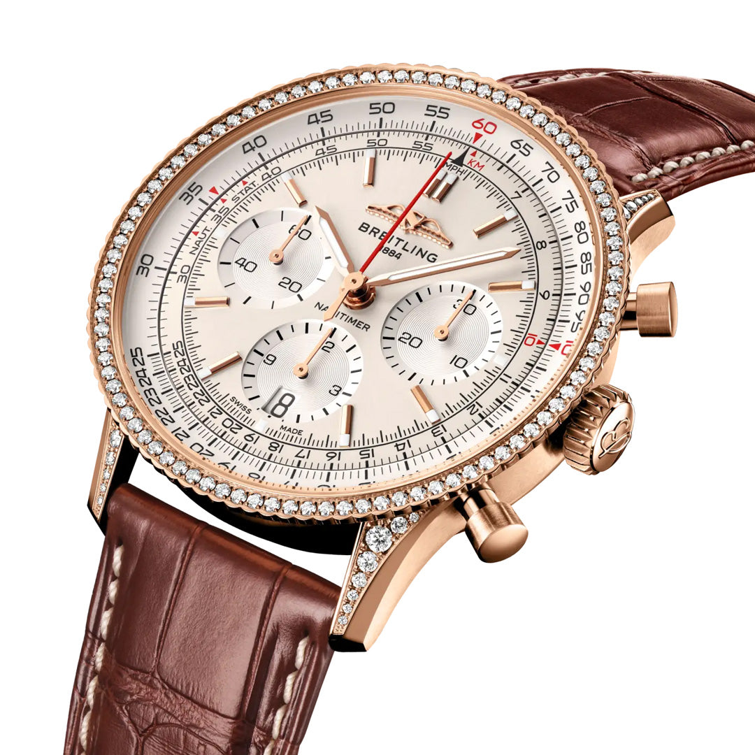 The Breitling Navitimer B01 Chronograph 41 is a luxurious wristwatch featuring a brown leather strap, gold case, diamond bezel, and white dial with three subdials and a date display—an iconic aviation timepiece recognized as the ultimate pilot’s chronograph.