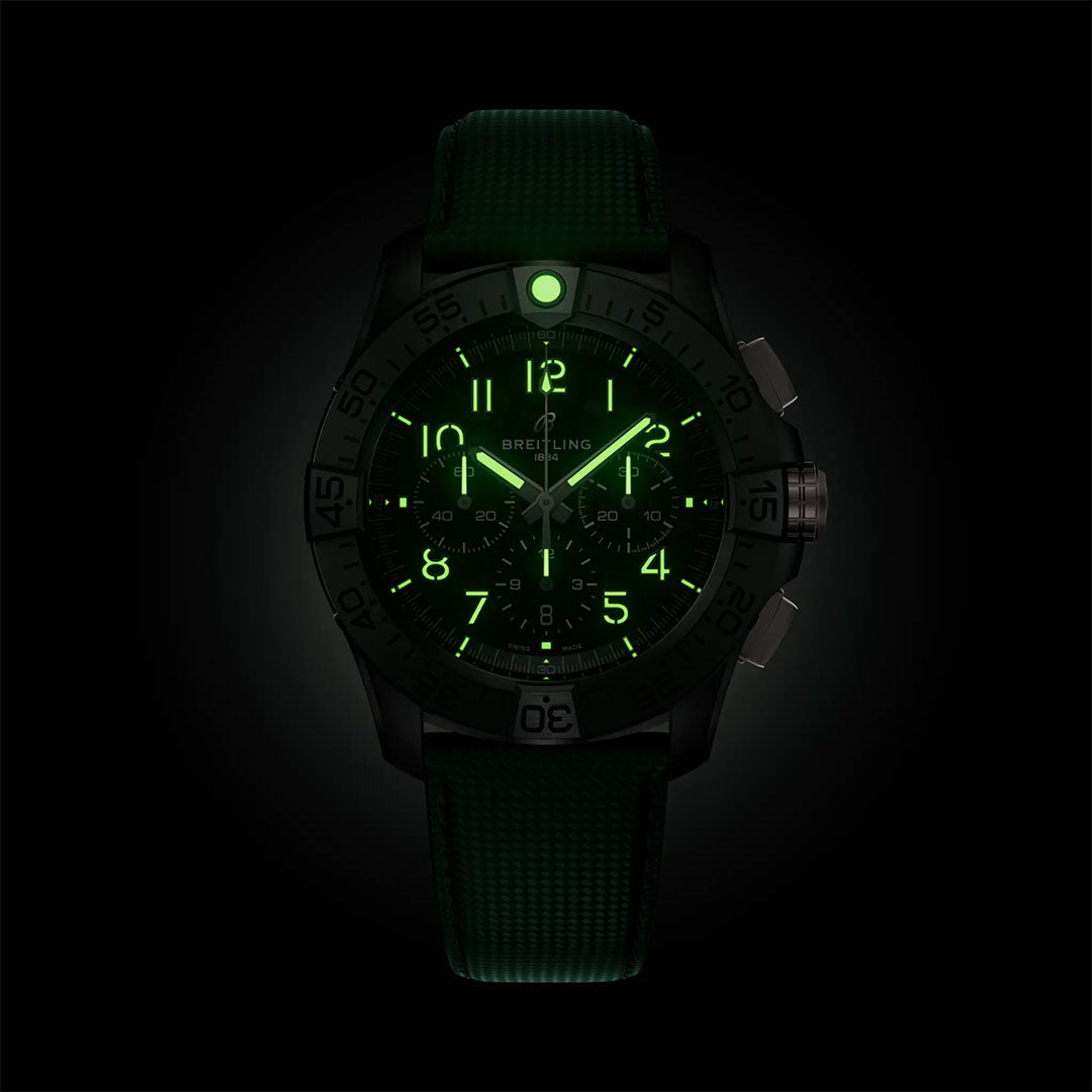 The Breitling Avenger B01 Chronograph 46 Night Mission features a dark case and green strap, with luminous green numbers, hands, and markers that glow in the dark, showcasing its military-inspired style.