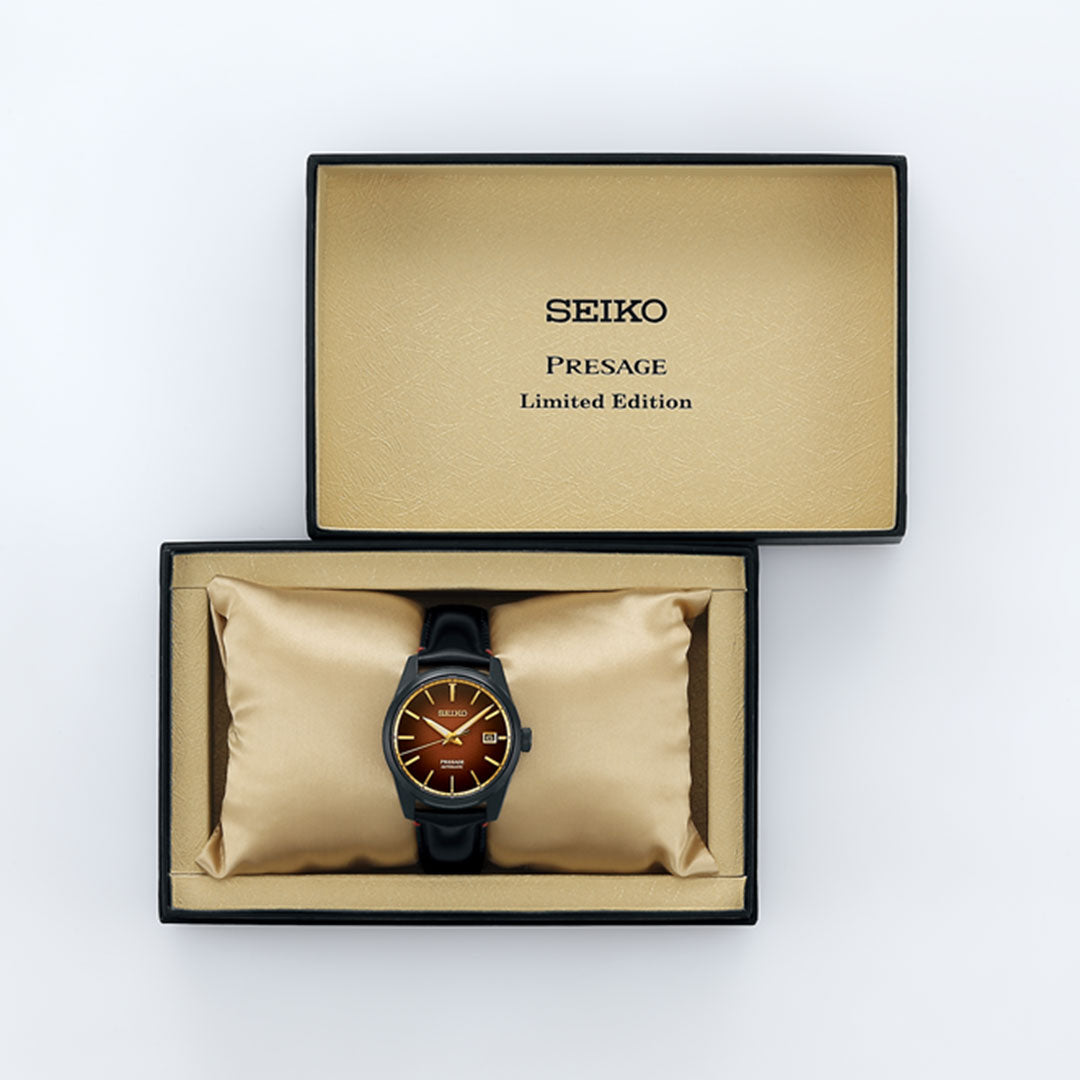 The Seiko Presage Sharp Edged Series Kabuki-Inspired Limited Edition (2,000 pcs) automatic 39mm watch features a brown face and black strap, displayed in an open black and gold presentation box with a cushioned interior.