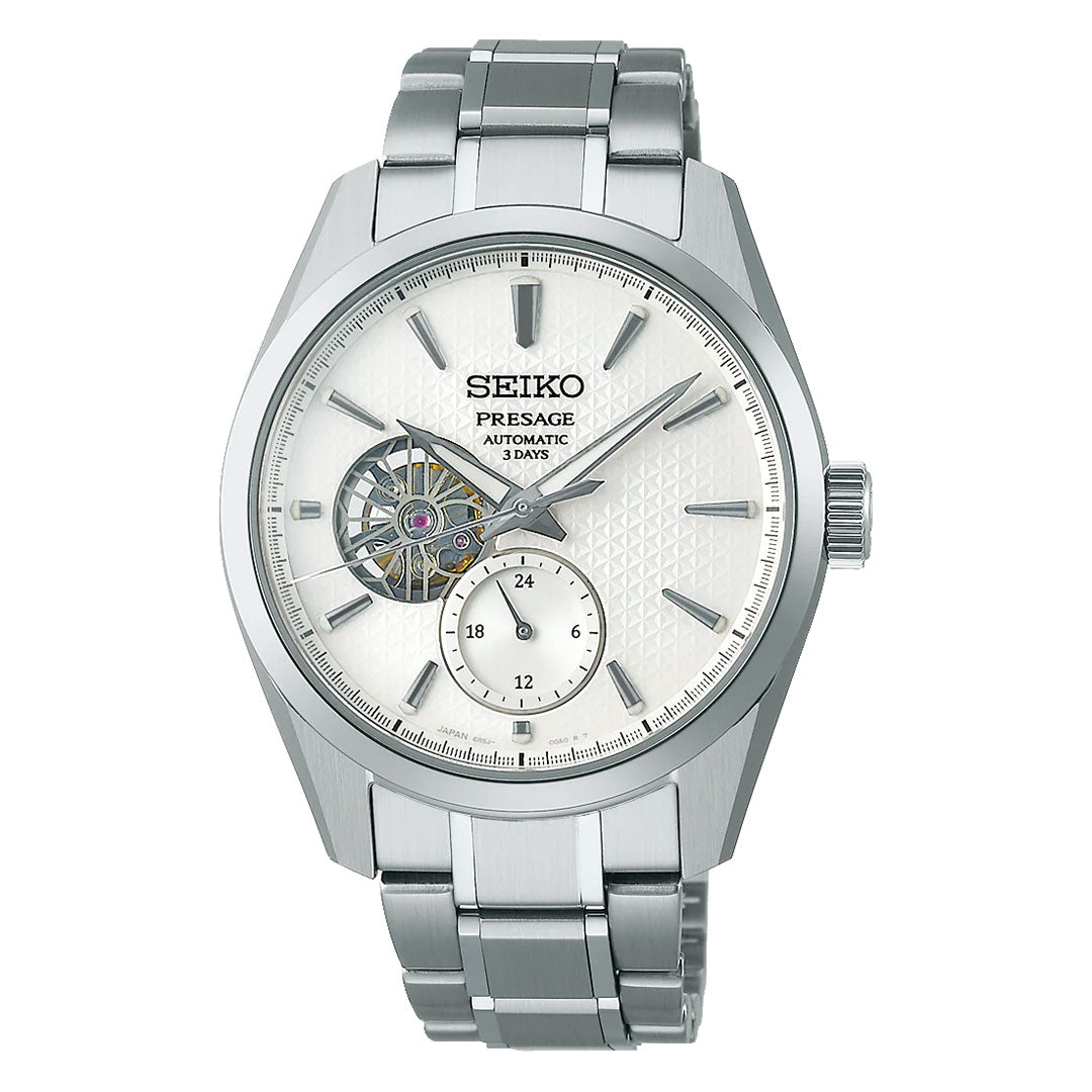 The Seiko Presage Sharp Edged Series Shiro Automatic features a 40.2mm case, silver stainless steel band, white textured dial, open-heart at 9 o’clock, and a 24-hour subdial at 6 o’clock.