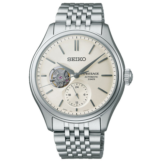 The sophisticated Seiko Presage Classic Series Automatic With Manual Winding 40.2mm Watch, in elegant silver, features a cream dial with an open-heart design and a small seconds sub-dial. It comes with a stainless steel bracelet, silver hour markers, and a right-side crown, showcasing the precise Caliber 6R35 mechanical movement.