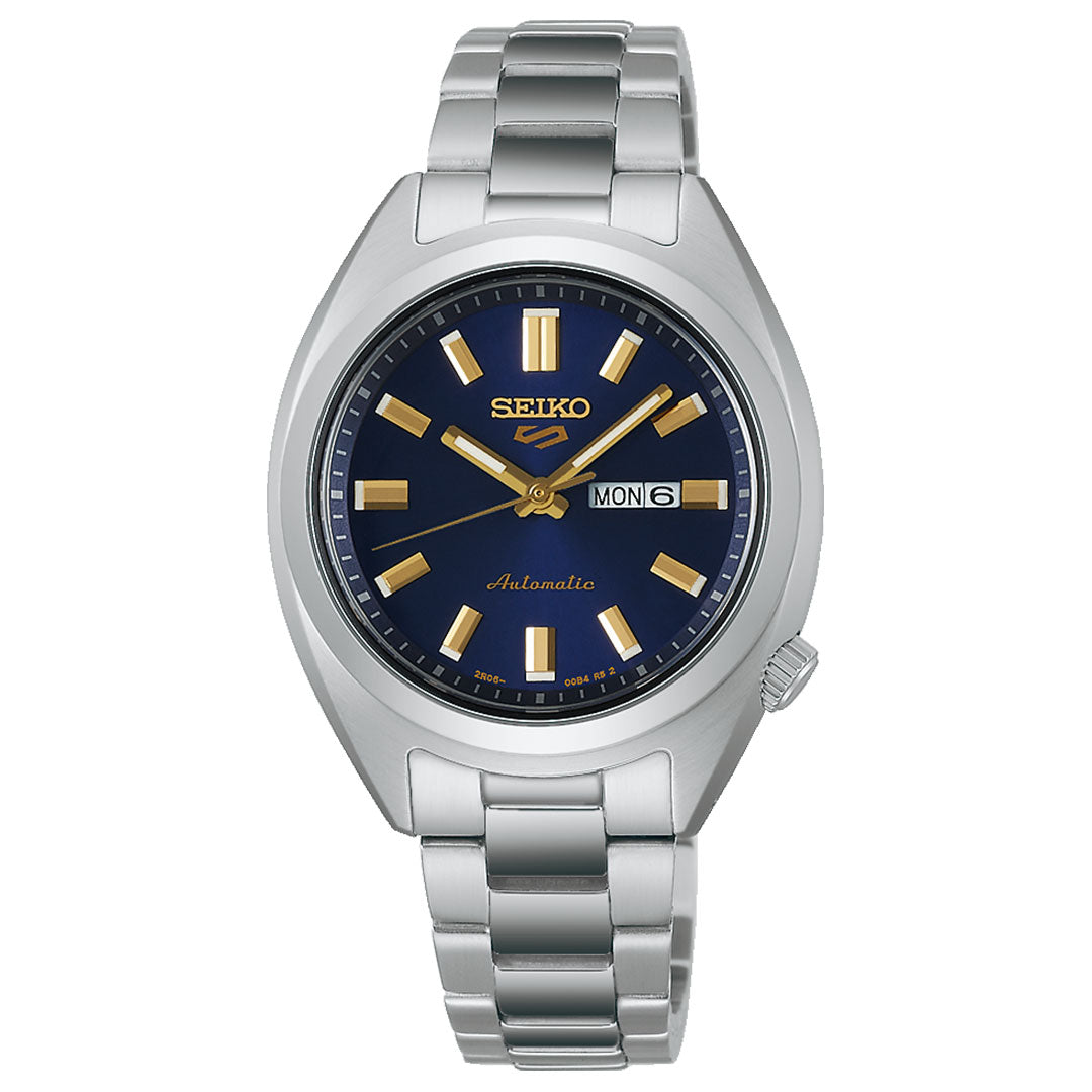 The Seiko 5 Sports SNXS Series Automatic 32mm Watch features a silver case, blue dial, gold hour markers and hands, date/day display at 3 o’clock, and a metal link bracelet.