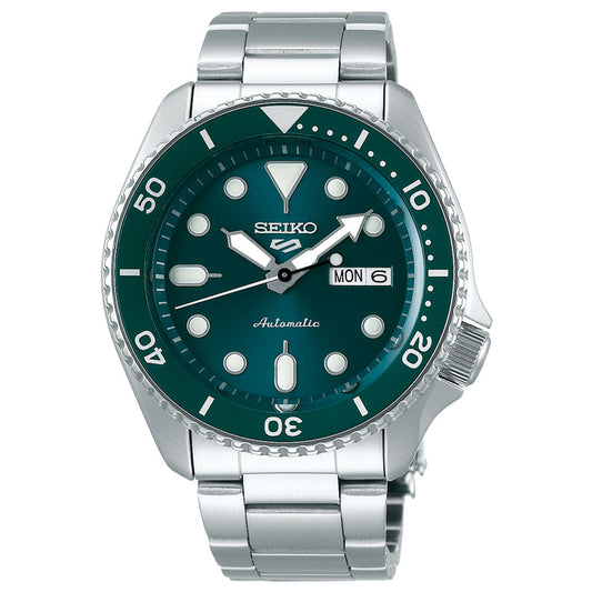 The Seiko 5 Sports SKX Series Automatic 42.5mm Watch from Seiko features a silver stainless steel band and a dark green bezel with impressive water resistance. Its face includes white hour markers, an elegant day-date display, and sleek silver hands. The bezel is detailed with numbers at ten-unit intervals, enhancing its sophisticated design.