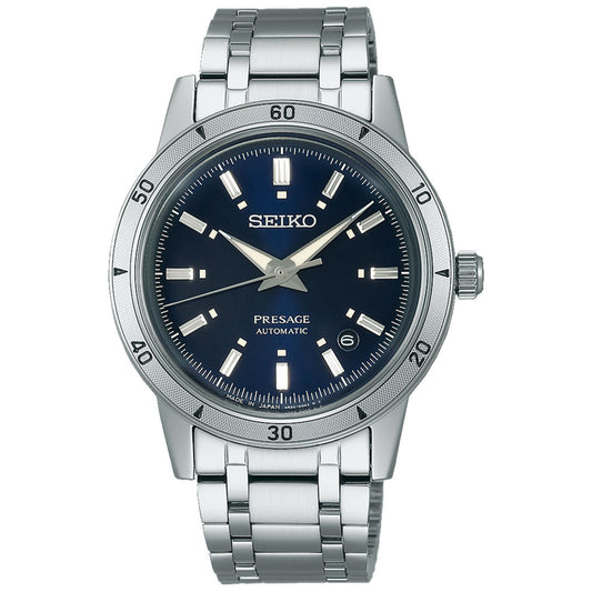 The Seiko Presage Style 60's Automatic with Manual Winding 39.5mm Watch exemplifies exquisite Japanese craftsmanship, featuring a silver stainless steel band and a dark blue dial. The dial is adorned with silver hour markers, a date display at the 3 o'clock position, and matching silver hands.