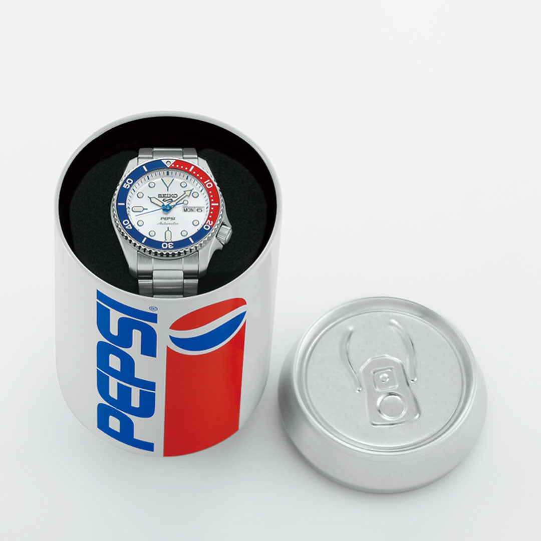 The Seiko 5 Sports SKX Series Pepsi Automatic 38mm Limited Edition watch (7,000 pieces) is shown inside an open Pepsi can-shaped container, its lid set to the right on a white surface.