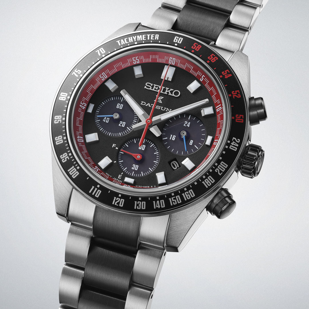The Seiko Prospex Speedtimer Datsun 240Z Solar 41.4mm Limited Edition watch, one of 4,000 pieces, features a stainless steel case, black and red bezel, three subdials, date display, and metal bracelet; shown angled on a light background.