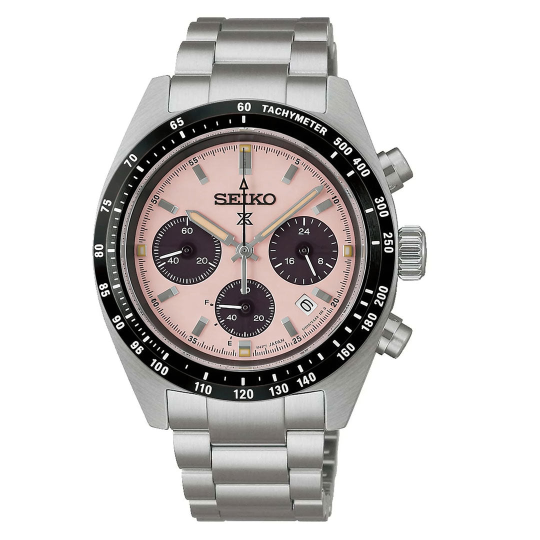 The Seiko Prospex Speedtimer Solar Chronograph 39mm Watch features a pink dial with three black subdials, date window, black tachymeter bezel, silver metal bracelet, and prominent side pushers.