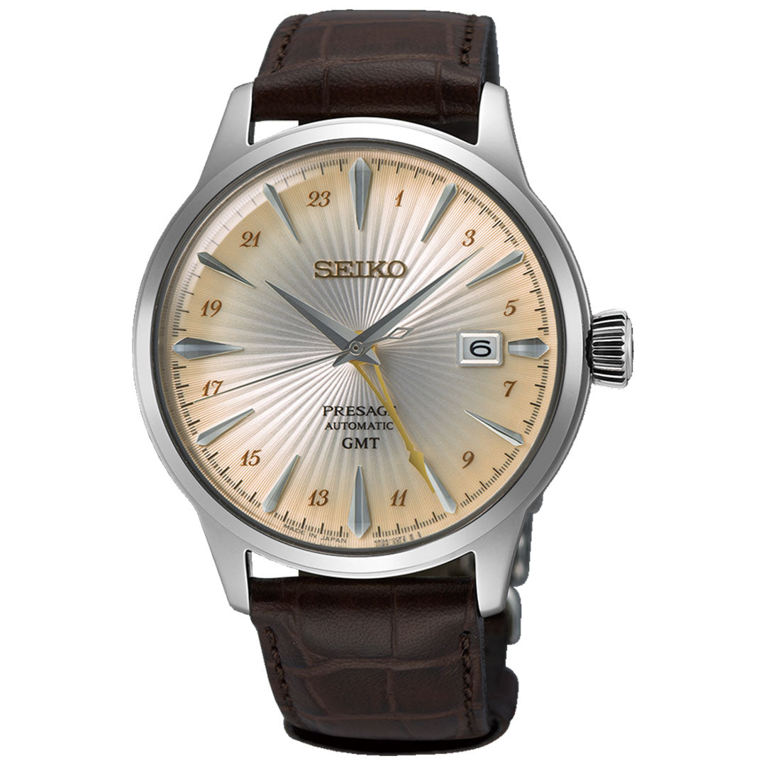 The Seiko Presage Cocktail Time Automatic Watch features a captivating cream sunburst dial complemented by a brown leather strap and silver hour markers. Powered by the reliable 4R36 automatic movement, it includes a date window at 3 o'clock and showcases an intricately stylish design.